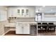 Elegant kitchen with white cabinets, granite countertops, wine cooler, and view to an outside bar area at 3369 Houle Ave, Sarasota, FL 34232