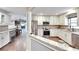 Modern kitchen with stainless steel appliances, white cabinetry, granite countertops, and hardwood floors at 3369 Houle Ave, Sarasota, FL 34232