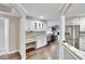 Bright kitchen with white cabinets, granite countertops, wine cooler, stainless steel fridge, and hardwood floors at 3369 Houle Ave, Sarasota, FL 34232