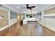 Spacious living area featuring hardwood floors, ample seating, and seamless transition to dining and kitchen areas at 3369 Houle Ave, Sarasota, FL 34232