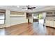 Bright and airy living room featuring hardwood floors, ceiling fan, and sliding glass doors to outdoor patio at 3369 Houle Ave, Sarasota, FL 34232