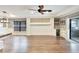 Spacious living room with hardwood floors, ceiling fan, modern lighting, and bar area with a beverage refrigerator at 3369 Houle Ave, Sarasota, FL 34232