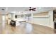 Open floor plan with hardwood floors, window bench seating, and bar area, connecting multiple living areas at 3369 Houle Ave, Sarasota, FL 34232