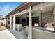 Outdoor kitchen with built in bar, stainless steel grill, television, and ceiling fan at 3369 Houle Ave, Sarasota, FL 34232