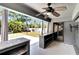 Covered outdoor patio features a ceiling fan and an outdoor kitchen area, leading to a spacious backyard at 3369 Houle Ave, Sarasota, FL 34232
