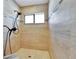 Shower featuring brown tile walls, bronze fixtures and a rain shower head at 3369 Houle Ave, Sarasota, FL 34232