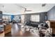 Spacious living room featuring hardwood floors, a ceiling fan, and large windows at 3875 Mariner Dr, St Petersburg, FL 33705