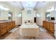 An amazing main bathroom featuring a large soaking tub, and vanities, and decorative tile at 4178 Des Prez Ct, Hernando Beach, FL 34607