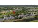 Community aerial view highlighting residences near a pond, playground, and surrounded by mature trees at 11321 Flora Springs Dr, Riverview, FL 33579