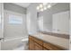 A clean bathroom is equipped with new tile floors, vanity, toilet, bath tub, and shower at 11321 Flora Springs Dr, Riverview, FL 33579
