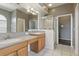 Bathroom featuring double sinks, walk-in shower, and tile flooring at 11321 Flora Springs Dr, Riverview, FL 33579