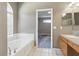 Bathroom featuring a soaking tub, a vanity with sink, and tile flooring at 11321 Flora Springs Dr, Riverview, FL 33579