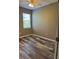 Cozy bedroom featuring wood-look floors and a bright window at 11321 Flora Springs Dr, Riverview, FL 33579