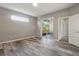 Bright bedroom with modern flooring, neutral paint, and sliding doors to an enclosed patio at 11321 Flora Springs Dr, Riverview, FL 33579