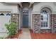 Welcoming front entrance with decorative stone pillars and a brick walkway at 11321 Flora Springs Dr, Riverview, FL 33579
