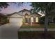 Beautiful home with a well-kept lawn, stone accents, and a two-car garage at 11321 Flora Springs Dr, Riverview, FL 33579