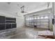 A clean two-car garage includes storage cabinets, space to park, and a garage door with windows at 11321 Flora Springs Dr, Riverview, FL 33579