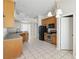 Bright kitchen area with tile flooring, stainless steel appliances, and wood cabinetry at 11321 Flora Springs Dr, Riverview, FL 33579