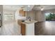 Kitchen featuring wood cabinets, tile flooring, and stainless steel sink and faucet at 11321 Flora Springs Dr, Riverview, FL 33579