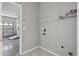 Functional laundry room with tile flooring and wire shelving at 11321 Flora Springs Dr, Riverview, FL 33579