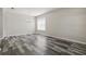 Bright living room featuring wood-look floors and a large window at 11321 Flora Springs Dr, Riverview, FL 33579