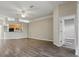 Open-concept living space with modern wood flooring, access to kitchen, and ceiling fan at 11321 Flora Springs Dr, Riverview, FL 33579