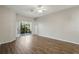 Bright living room with wood flooring and glass sliding door to an outdoor patio at 11321 Flora Springs Dr, Riverview, FL 33579