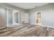 Spacious main bedroom with wood-look floors, access to patio, and ensuite bathroom at 11321 Flora Springs Dr, Riverview, FL 33579