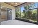 Enclosed tile patio offering relaxing outdoor space, views of lush greenery, and screened windows at 11321 Flora Springs Dr, Riverview, FL 33579