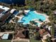 Aerial view of pool and tennis courts, showcasing the community's recreational facilities and manicured grounds at 1141 Jameson Greens Dr # 3, Sun City Center, FL 33573