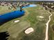 Beautiful aerial view of a well-maintained golf course with sand traps and a scenic pond at 1141 Jameson Greens Dr # 3, Sun City Center, FL 33573