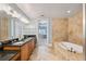 A bathroom with a tub, double sinks, and tile flooring at 2825 Terra Ceia Bay Blvd # 1902, Palmetto, FL 34221