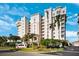 Elegant high-rise condo with a beautifully landscaped entrance and lush tropical trees at 2825 Terra Ceia Bay Blvd # 1902, Palmetto, FL 34221