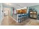 Kitchen and bar seating area, tile flooring, and pendant lighting and wood cabinets at 2825 Terra Ceia Bay Blvd # 1902, Palmetto, FL 34221