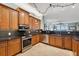 Kitchen featuring custom wood cabinets, granite countertops, and stainless steel appliances and adjacent living space at 2825 Terra Ceia Bay Blvd # 1902, Palmetto, FL 34221
