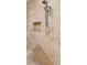 Close-up of tiled shower featuring a handheld shower head, built-in niche, and neutral color scheme at 2825 Terra Ceia Bay Blvd # 1902, Palmetto, FL 34221