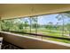Balcony offering scenic golf course views with lush greenery and mature trees at 36750 Us Highway 19 # 21-301, Palm Harbor, FL 34684