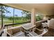 Balcony with a patio table set overlooking a lush golf course and mature trees at 36750 Us Highway 19 # 21-301, Palm Harbor, FL 34684