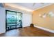 Bedroom with hardwood floors and sliding glass doors leading to a balcony with seating at 36750 Us Highway 19 # 21-301, Palm Harbor, FL 34684