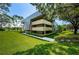 Exterior of a modern condo building with well-maintained landscaping and manicured lawns at 36750 Us Highway 19 # 21-301, Palm Harbor, FL 34684