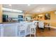 Bright kitchen with white cabinets, granite countertops, bar seating, and a view of the dining area at 36750 Us Highway 19 # 21-301, Palm Harbor, FL 34684