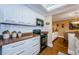 Well-equipped kitchen featuring white cabinets, stainless steel appliances, and a breakfast bar at 36750 Us Highway 19 # 21-301, Palm Harbor, FL 34684