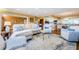 Spacious living room with stylish furniture, a large rug, and an open layout to the kitchen at 36750 Us Highway 19 # 21-301, Palm Harbor, FL 34684