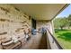 Brick patio with outdoor seating, offering a relaxing space with a view of the lush landscaping at 36750 Us Highway 19 # 21-301, Palm Harbor, FL 34684
