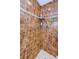 Close-up of an elegant shower with marble tiling, shower products, and modern fixtures at 36750 Us Highway 19 # 21-301, Palm Harbor, FL 34684