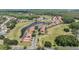 Aerial view of community showcasing residential homes along water with a golf course and ponds at 394 Tall Oak Trl, Tarpon Springs, FL 34688