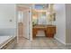 Bathroom vanity area adjacent to tub and shower at 394 Tall Oak Trl, Tarpon Springs, FL 34688