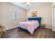 Cozy bedroom features wood floors, blue headboard, with plenty of natural light from a window at 394 Tall Oak Trl, Tarpon Springs, FL 34688