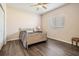 Cozy bedroom featuring wood floors, neutral walls, and a ceiling fan at 394 Tall Oak Trl, Tarpon Springs, FL 34688