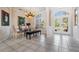 Bright dining room featuring tile floors, glass table, and view of front yard at 394 Tall Oak Trl, Tarpon Springs, FL 34688